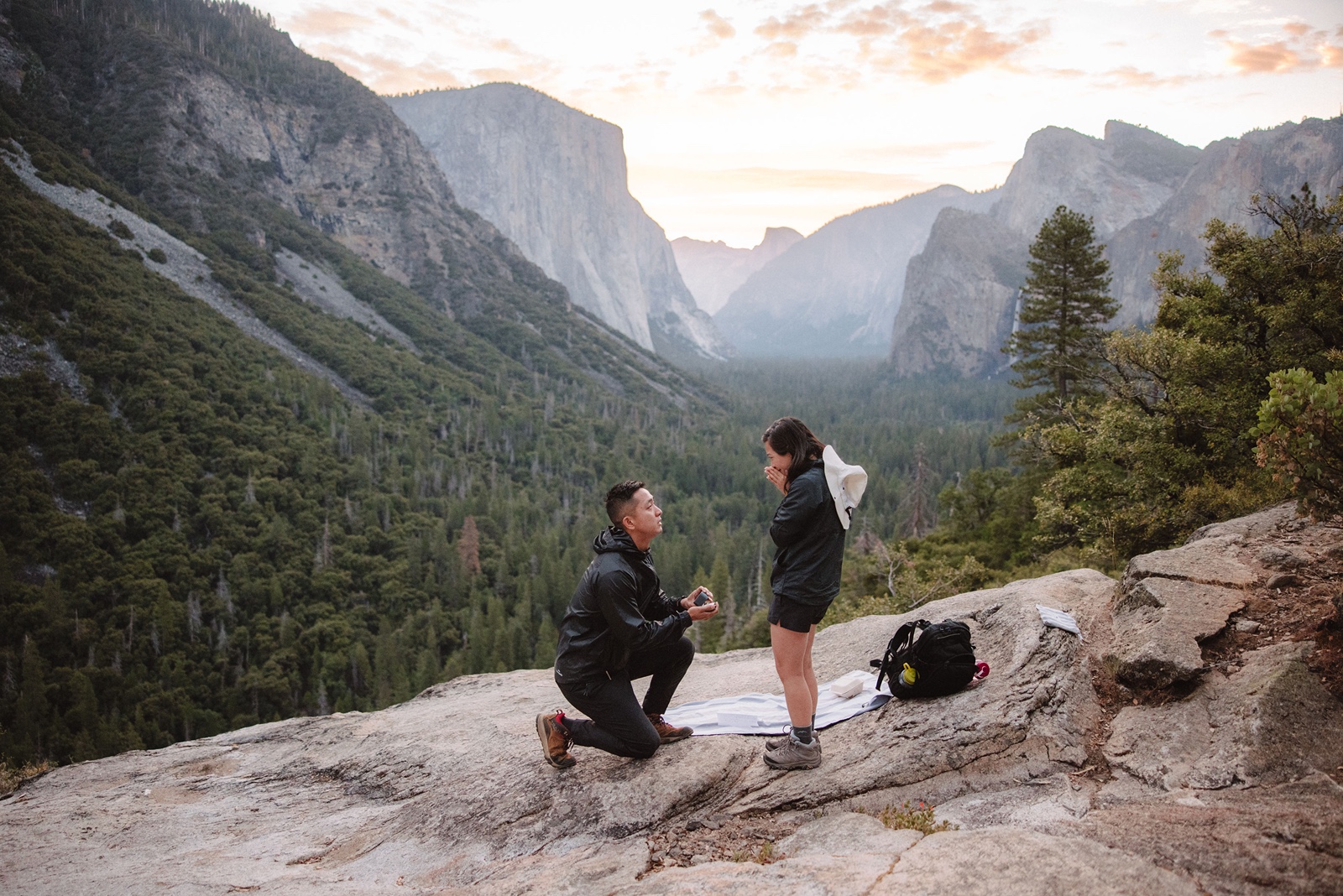 Man on one knee surprise proposing in Yosemite