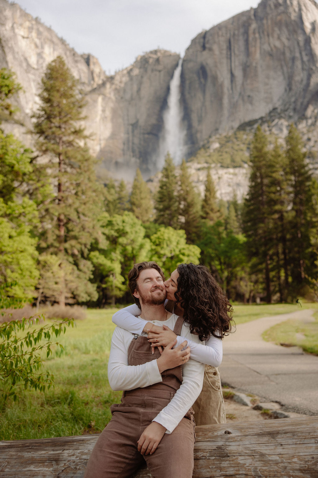 Woman kisses man on the cheek during Yosemite proposal photos