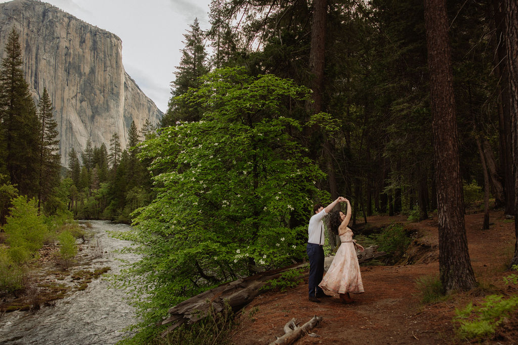 Man and woman dance in Yosemite National Park during engagement photos