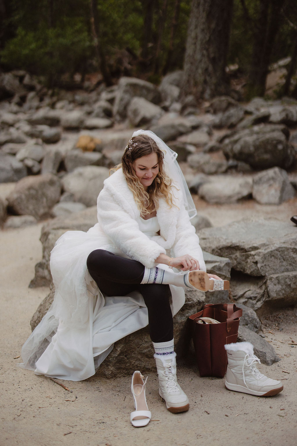 Bride changing elopement shoes mid-day